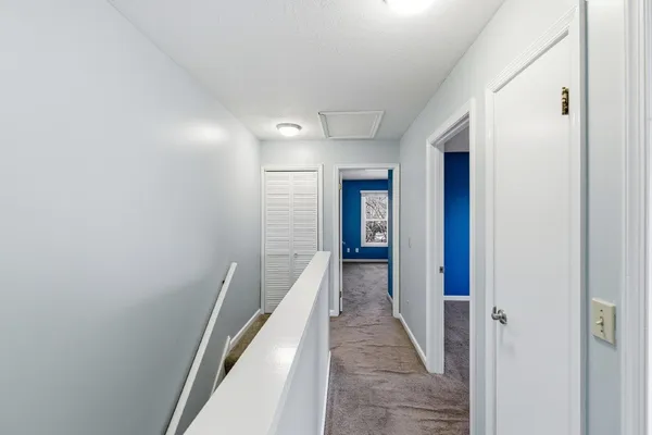a hallway with wooden floor and entryway