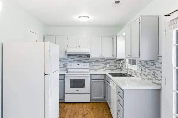 a kitchen with a sink stove and refrigerator