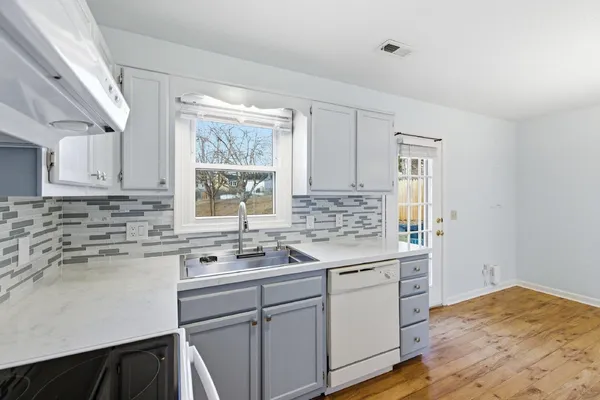 a kitchen with a sink stove and cabinets