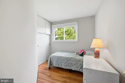 a bedroom with a bed and a lamp