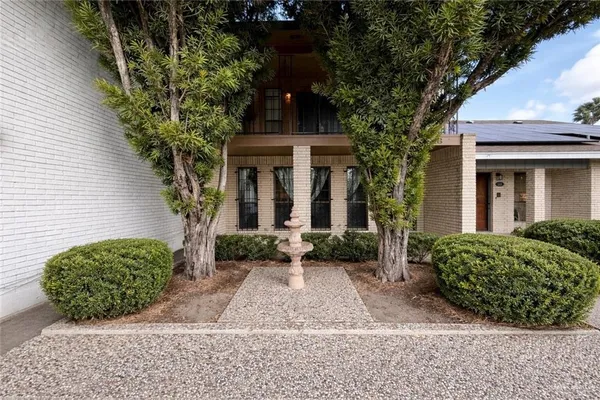 a front view of a house with garden