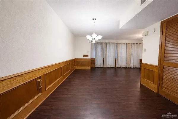 a view of a room with wooden floor and staircase
