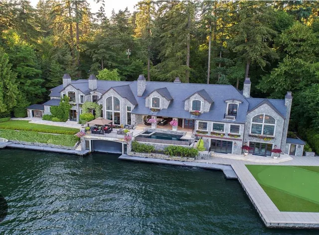 a aerial view of a house with a yard table and chairs