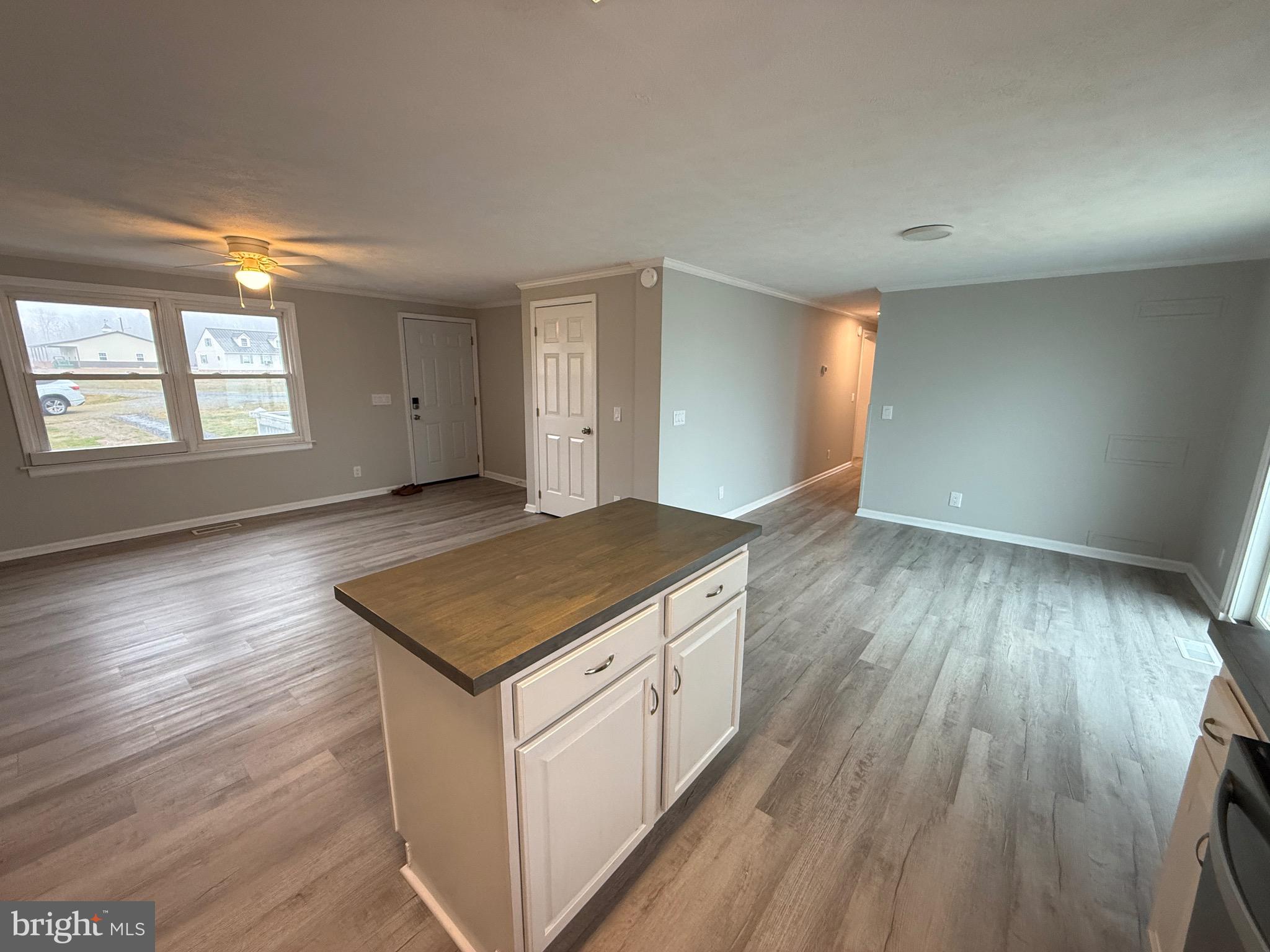299 Blue Crab Loop Montross, VA 22520 - Photo 13 of 30 an empty room with wooden floor and windows