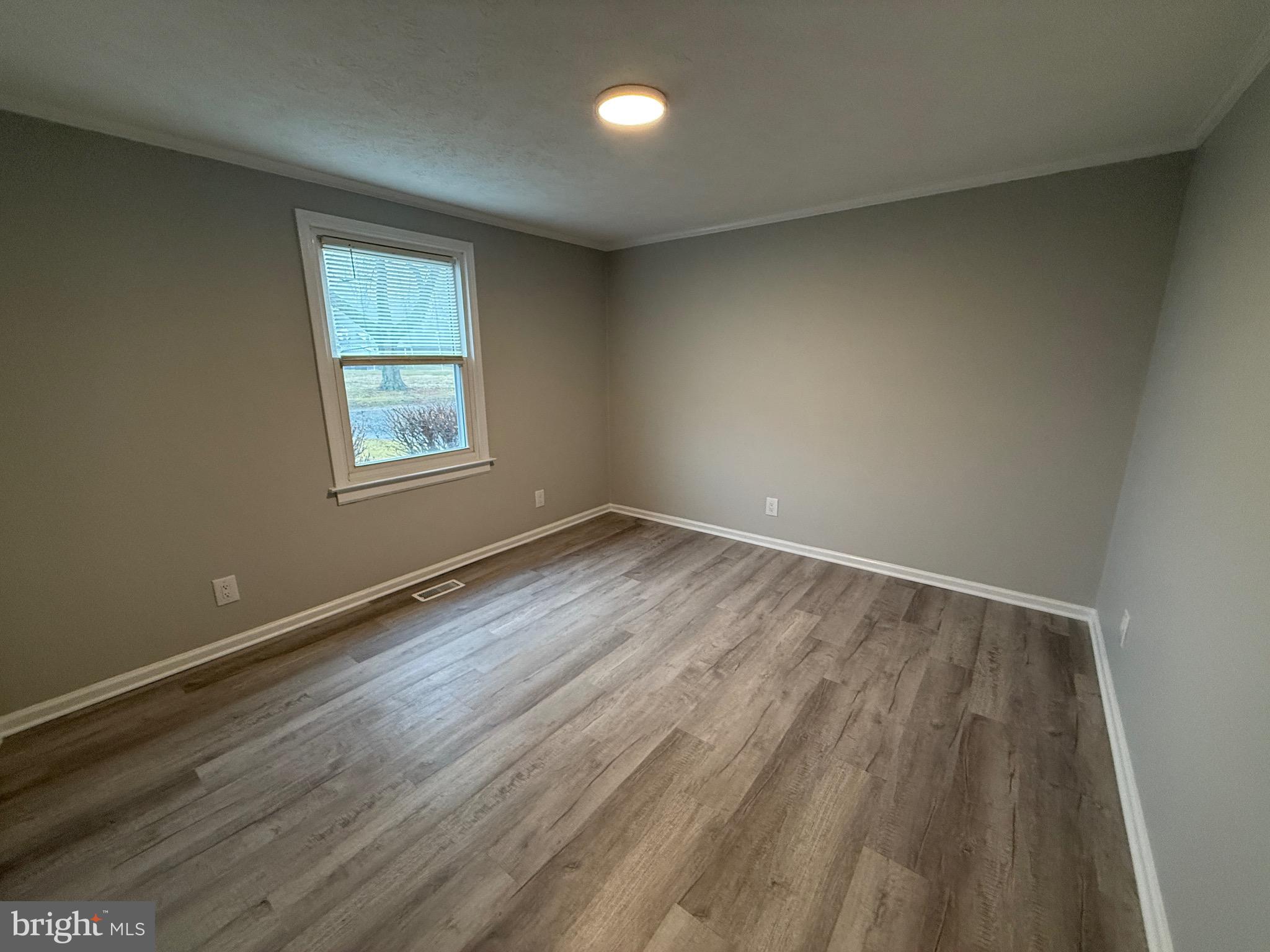 299 Blue Crab Loop Montross, VA 22520 - Photo 18 of 30 an empty room with wooden floor and windows