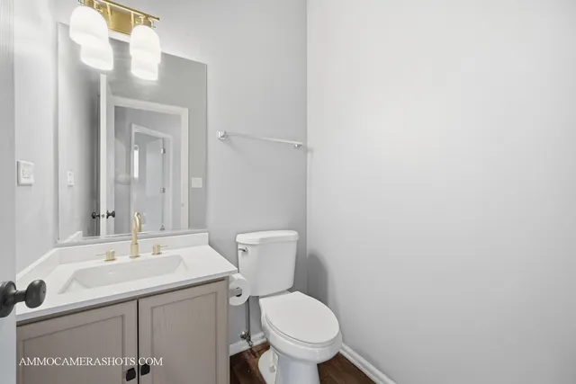 a bathroom with a sink mirror and toilet