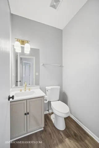 a bathroom with a toilet a sink and mirror