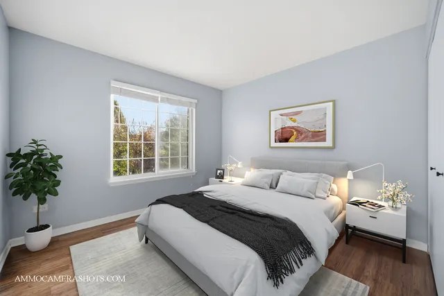 a bedroom with bed and a potted plant