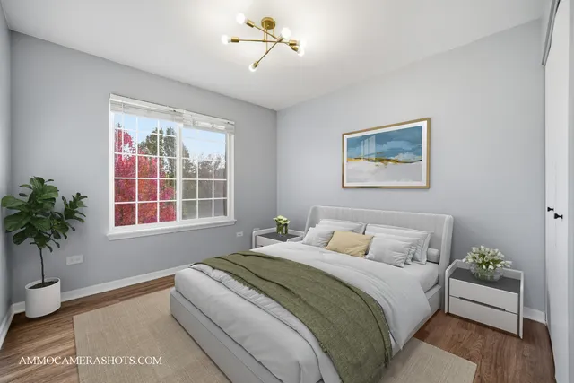 a bedroom with bed and a potted plant