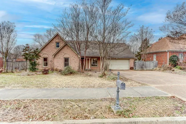 a view of a white house with a yard covered in snow