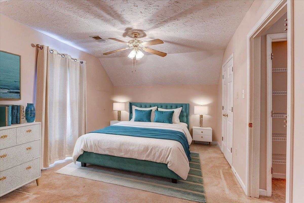 775 Silverman Drive Collierville, TN 38017 - Photo 12 of 17 a bedroom with a large bed and a chandelier