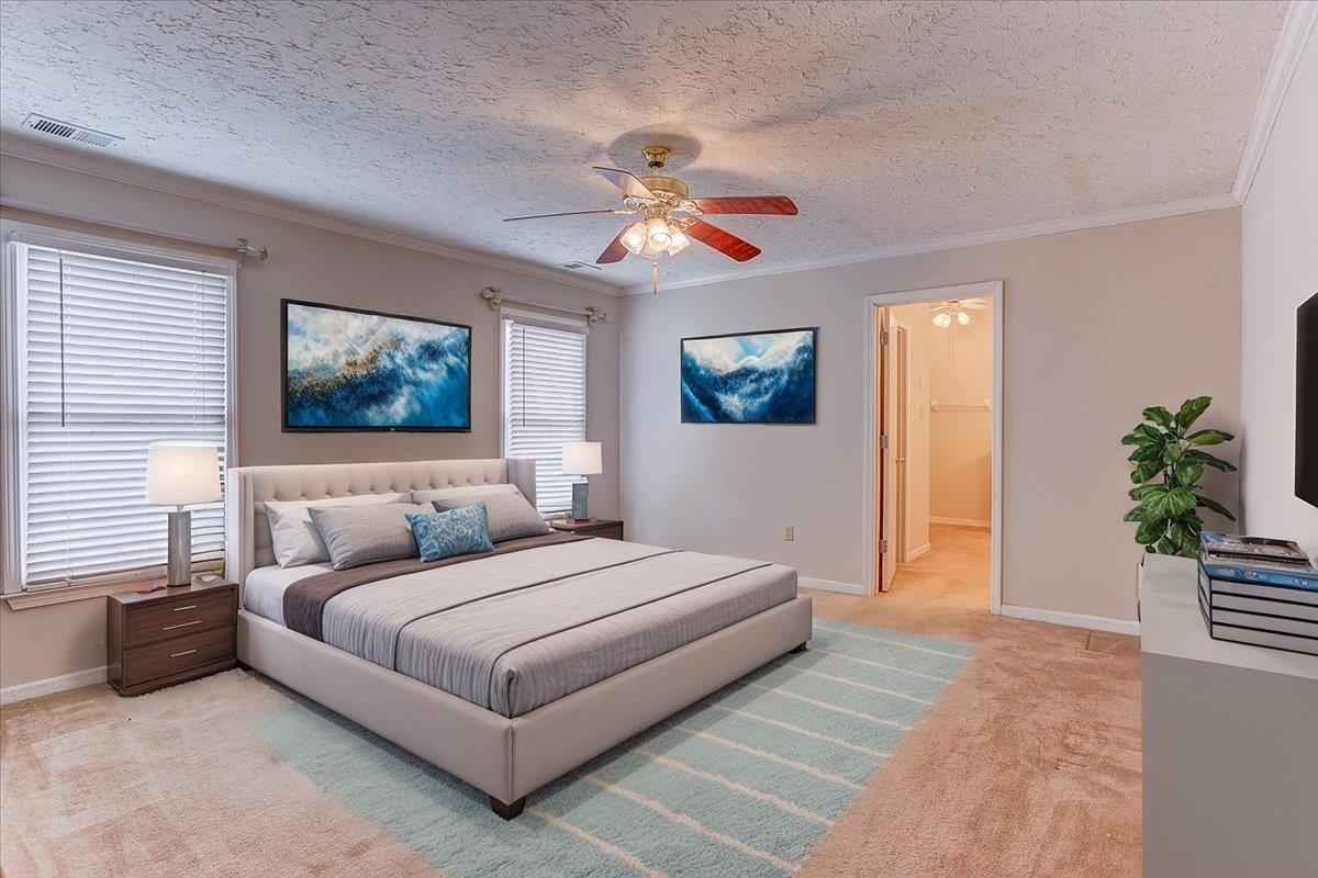 775 Silverman Drive Collierville, TN 38017 - Photo 7 of 17 a bedroom with a large bed a chandelier and a window