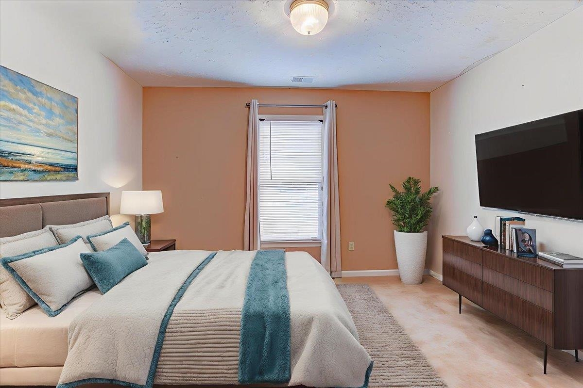 775 Silverman Drive Collierville, TN 38017 - Photo 10 of 17 a bedroom with a bed and a flat screen tv