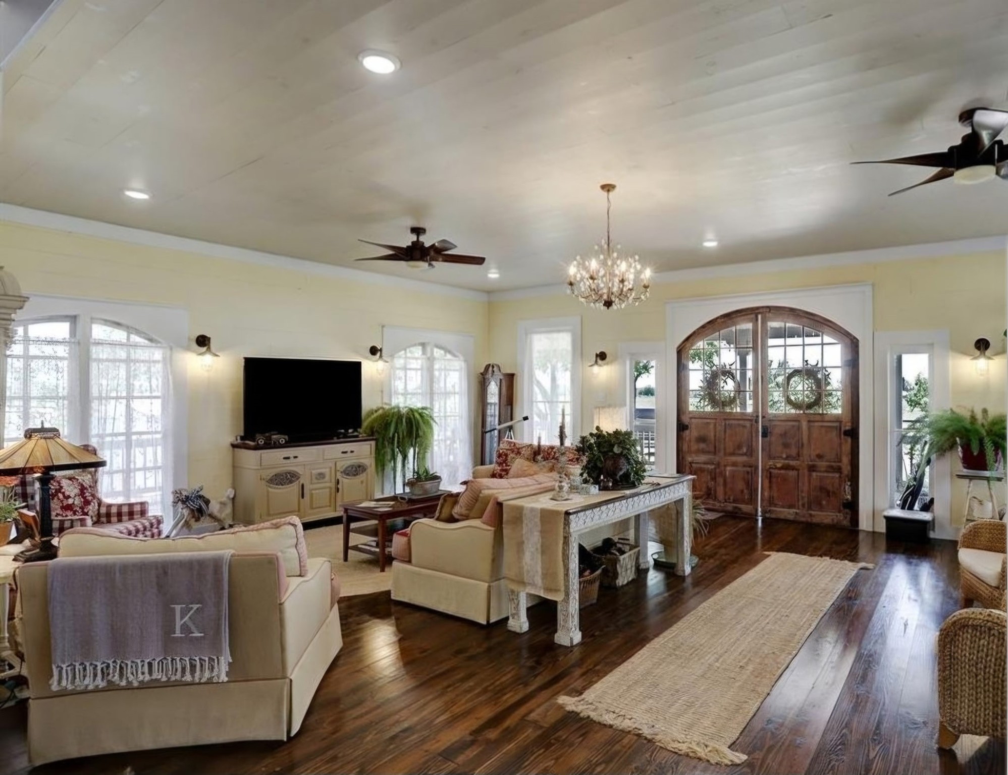 1098 Post Oak Point Road Fayetteville, TX 78940 - Photo 4 of 14 a living room with furniture a chandelier a flat screen tv and a fireplace