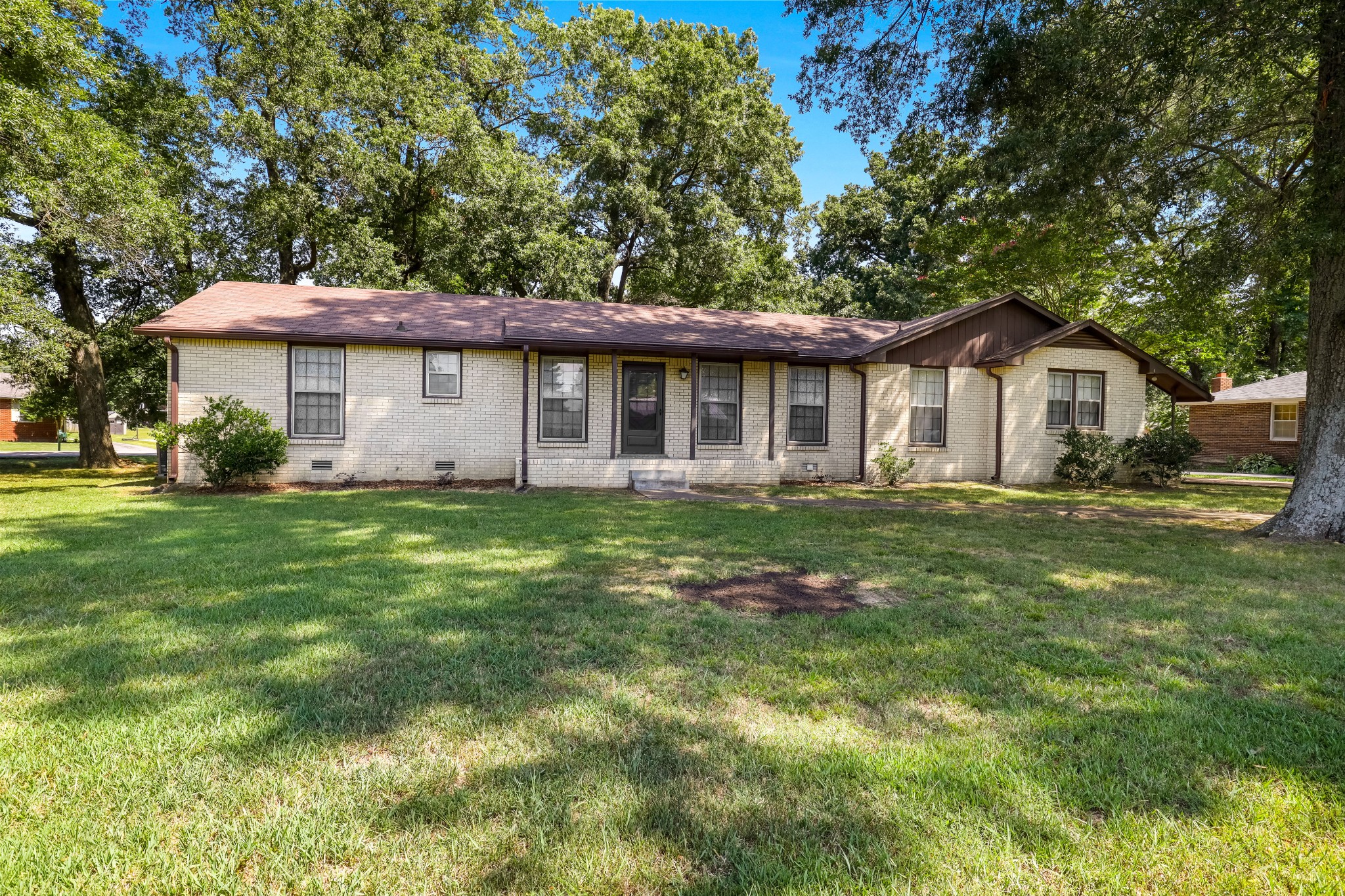 a front view of a house with a garden