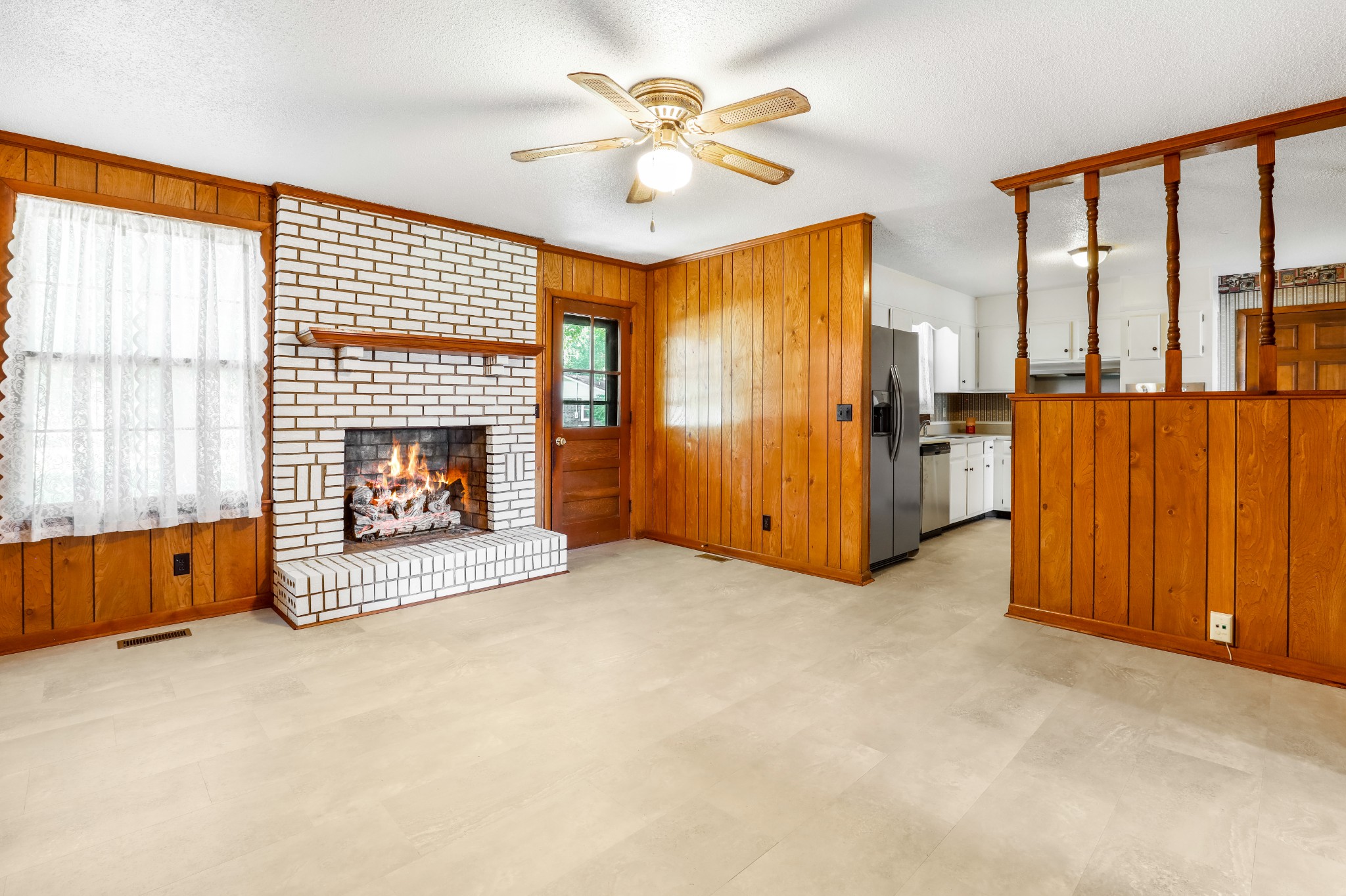 4169 Allison Lane Springfield, TN 37172 - Photo 13 of 21 an empty room with windows a fireplace and a chandelier fan