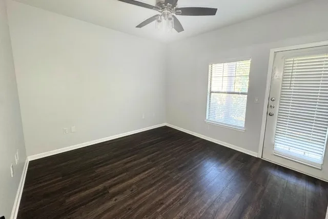 wooden floor in an empty room with a window