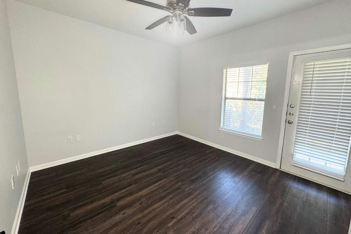 11203 Ranch Road 2222, Unit 2203 Austin, TX 78730 - Photo 11 of 34 wooden floor in an empty room with a window