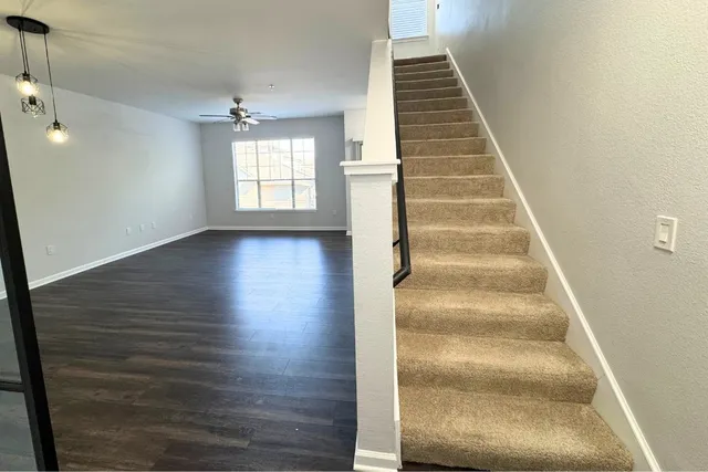a view of entryway and hall with wooden floor