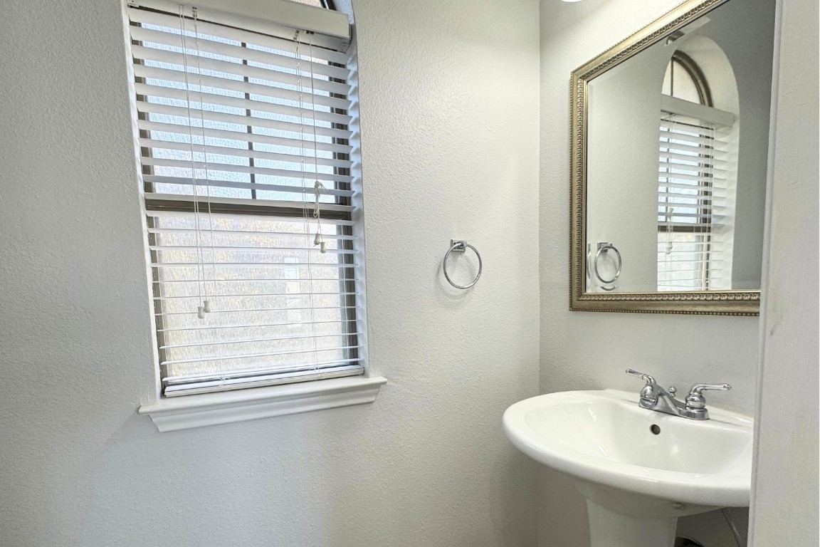 11203 Ranch Road 2222, Unit 2203 Austin, TX 78730 - Photo 22 of 34 a bathroom with a sink and a mirror