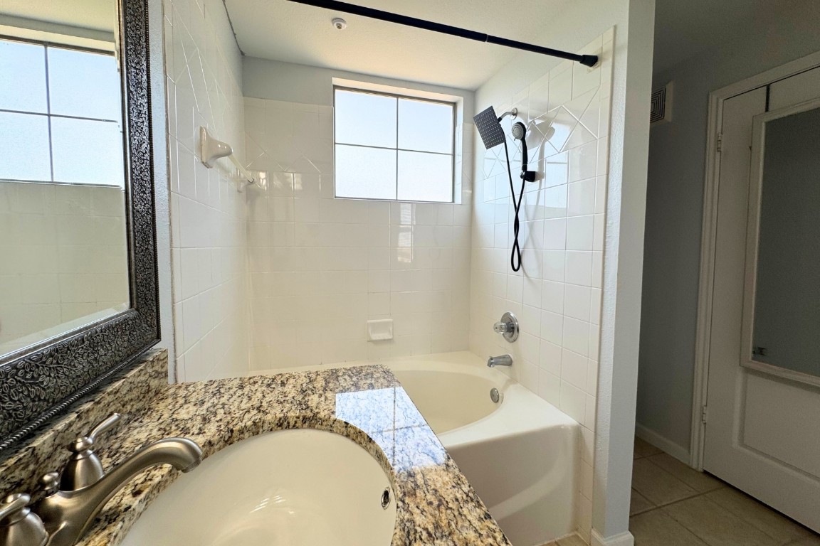 11203 Ranch Road 2222, Unit 2203 Austin, TX 78730 - Photo 26 of 34 a bathroom with a tub sink and mirror