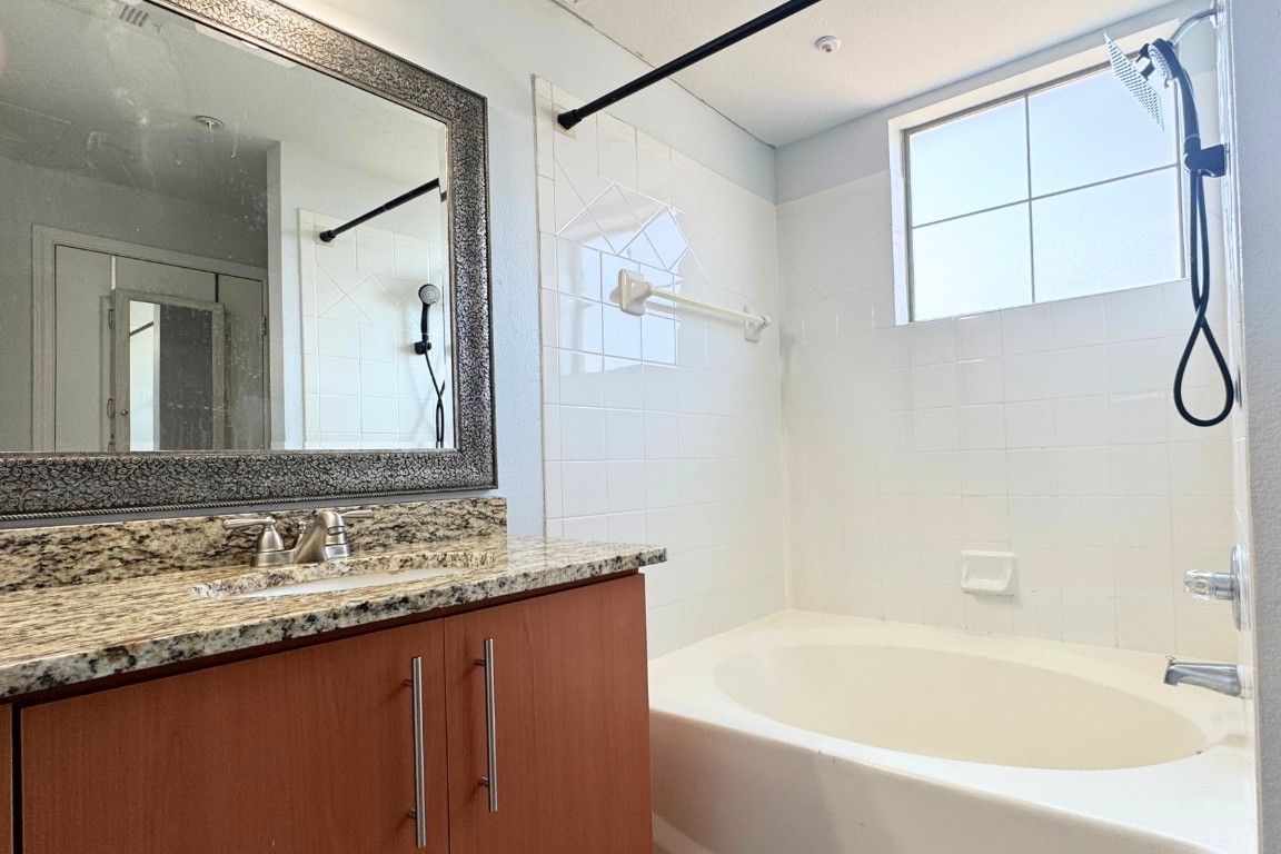 11203 Ranch Road 2222, Unit 2203 Austin, TX 78730 - Photo 27 of 34 a bathroom with a bathtub and a sink