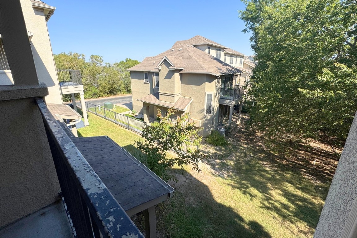 11203 Ranch Road 2222, Unit 2203 Austin, TX 78730 - Photo 31 of 34 a view of a house with a yard
