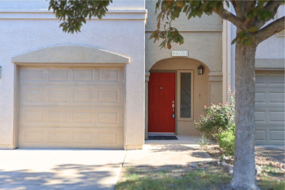 11203 Ranch Road 2222, Unit 2203 Austin, TX 78730 - Photo 7 of 34 a front view of a house with a yard