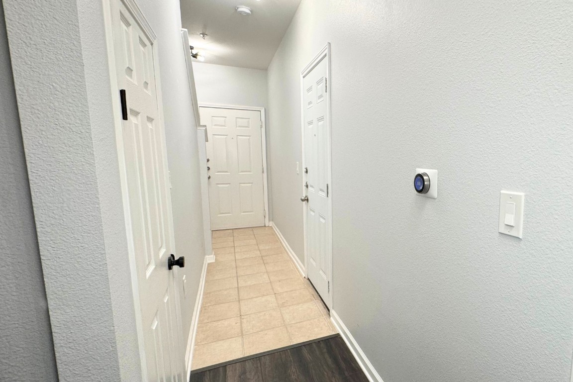 11203 Ranch Road 2222, Unit 2203 Austin, TX 78730 - Photo 10 of 34 a view of a hallway with wooden floor and staircase