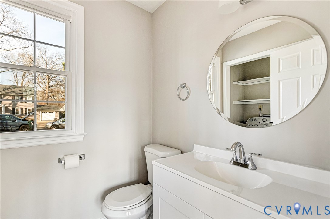 2139 Esquire Road North Chesterfield, VA 23235 - Photo 11 of 35 a bathroom with a toilet a sink a mirror and a window