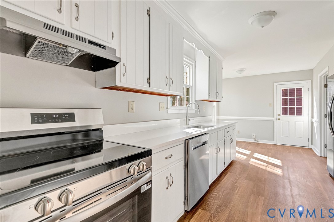 2139 Esquire Road North Chesterfield, VA 23235 - Photo 5 of 35 a kitchen with a stove oven and white cabinets