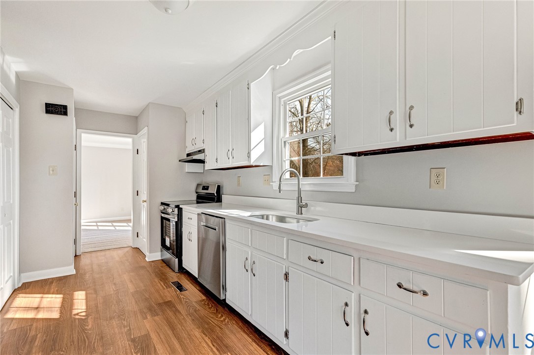 2139 Esquire Road North Chesterfield, VA 23235 - Photo 7 of 35 a kitchen with white cabinets sink and stove