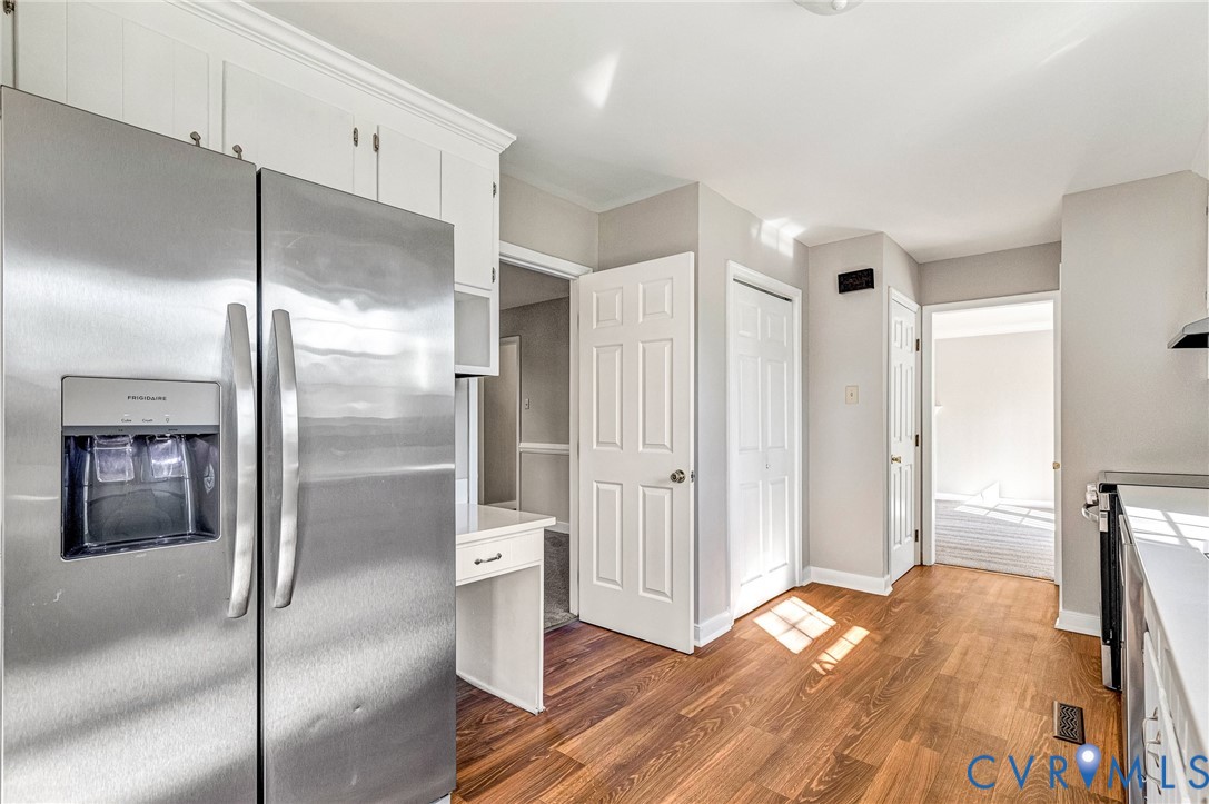 2139 Esquire Road North Chesterfield, VA 23235 - Photo 8 of 35 a view of kitchen with refrigerator cabinet and wooden floor