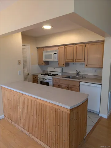 a kitchen with stainless steel appliances a microwave a sink and cabinets