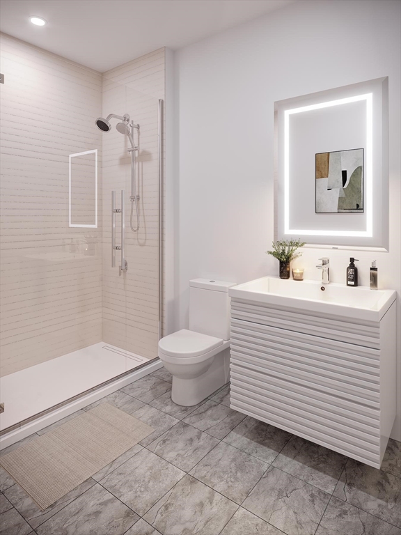 45 Bartlett Crescent, Unit 305 Brookline, MA 02446 - Photo 5 of 6 a bathroom with a sink toilet and shower