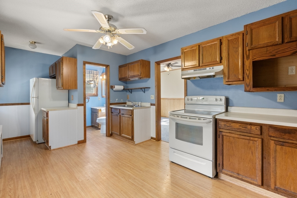 358 East Street, Unit 358 Ludlow, MA 01056 - Photo 4 of 10 a kitchen with cabinets wooden floor and stainless steel appliances
