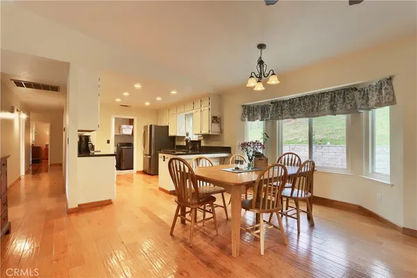 a view of a dining room with furniture window and wooden floor
