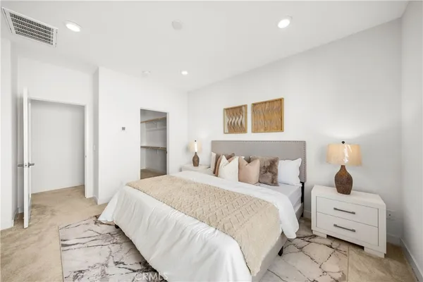 a bedroom with bed and cabinets