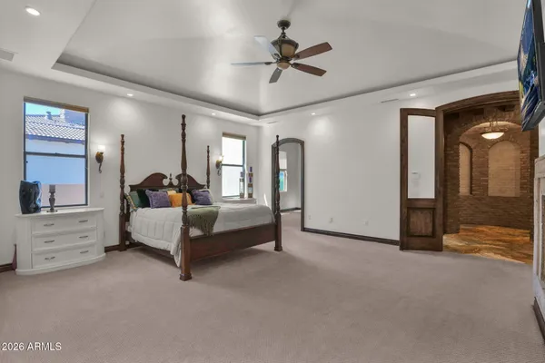 a spacious bathroom with a tub shower and mirror