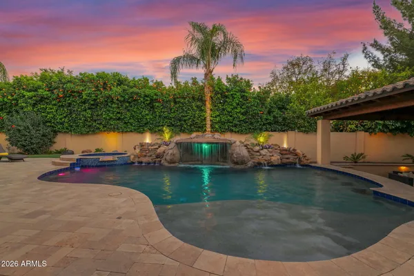 a view of a swimming pool with a yard