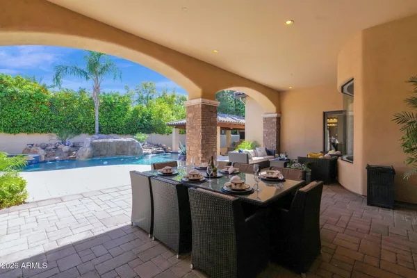 a view of a house with swimming pool and sitting area