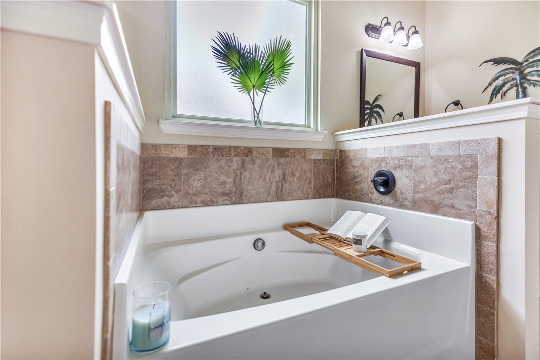 144 Buckland Drive Anderson, SC 29621 - Photo 8 of 48 Indulge in relaxation with this serene bathroom, featuring a deep soaking tub and tiled surround.