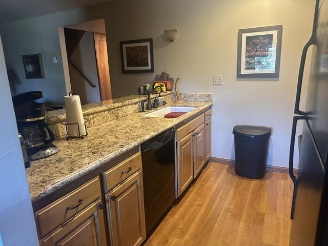25 Lee Road, Unit 106 Mammoth Lakes, CA 93546 - Photo 2 of 16 Kitchen featuring wood-finish flooring, granite-look countertops, and light wood cabinetry