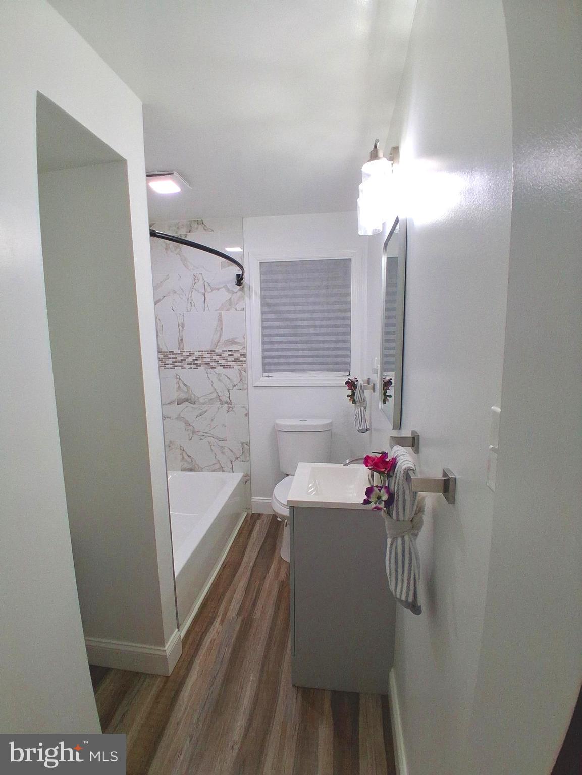 1225 Landover Road Rosedale, MD 21237 - Photo 13 of 48 a bathroom with a tub sink and mirror