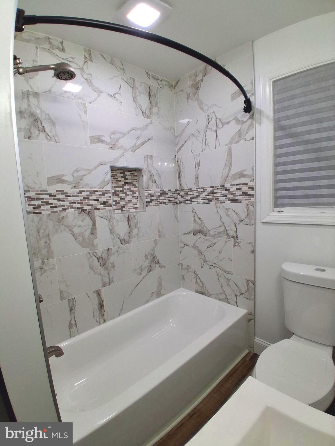 1225 Landover Road Rosedale, MD 21237 - Photo 16 of 48 a bathroom with a bathtub and shower