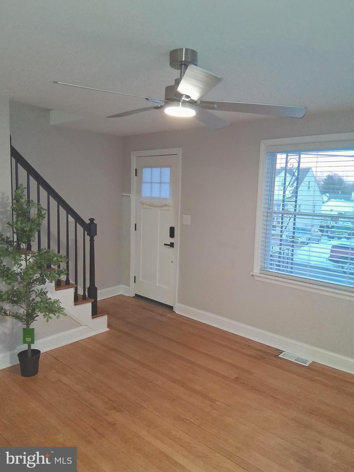 1225 Landover Road Rosedale, MD 21237 - Photo 20 of 48 a view of an empty room with wooden floor and a chandelier