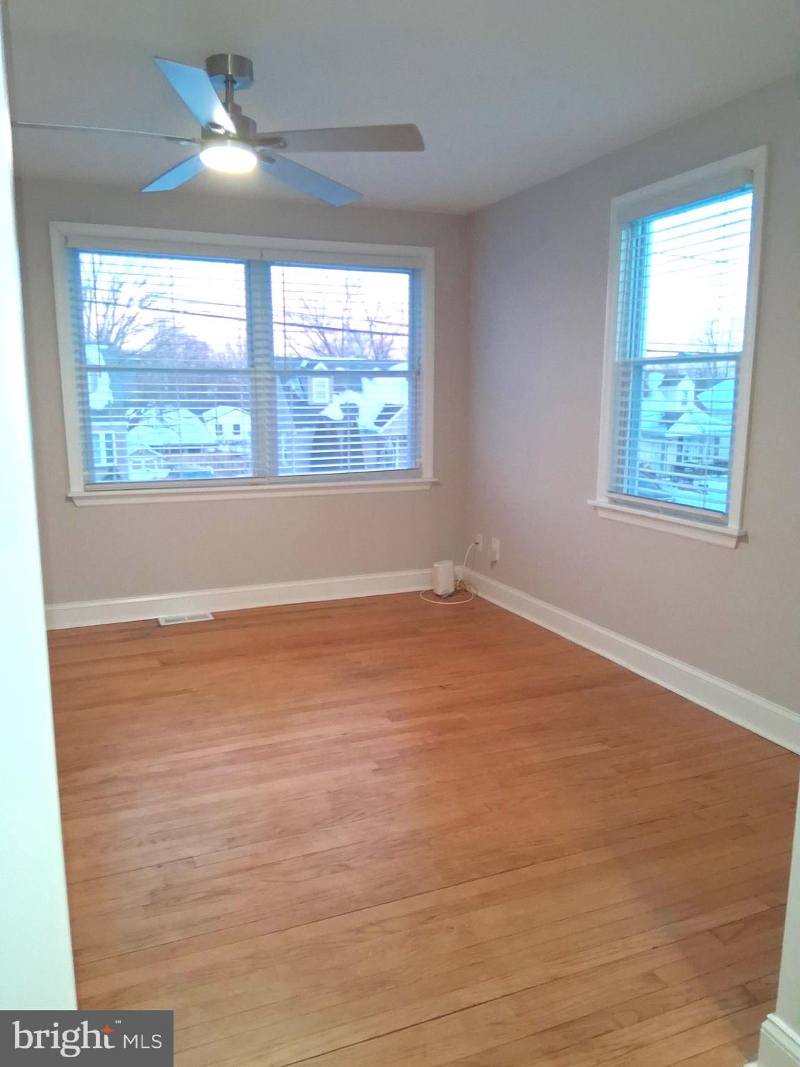 1225 Landover Road Rosedale, MD 21237 - Photo 21 of 48 an empty room with wooden floor and windows