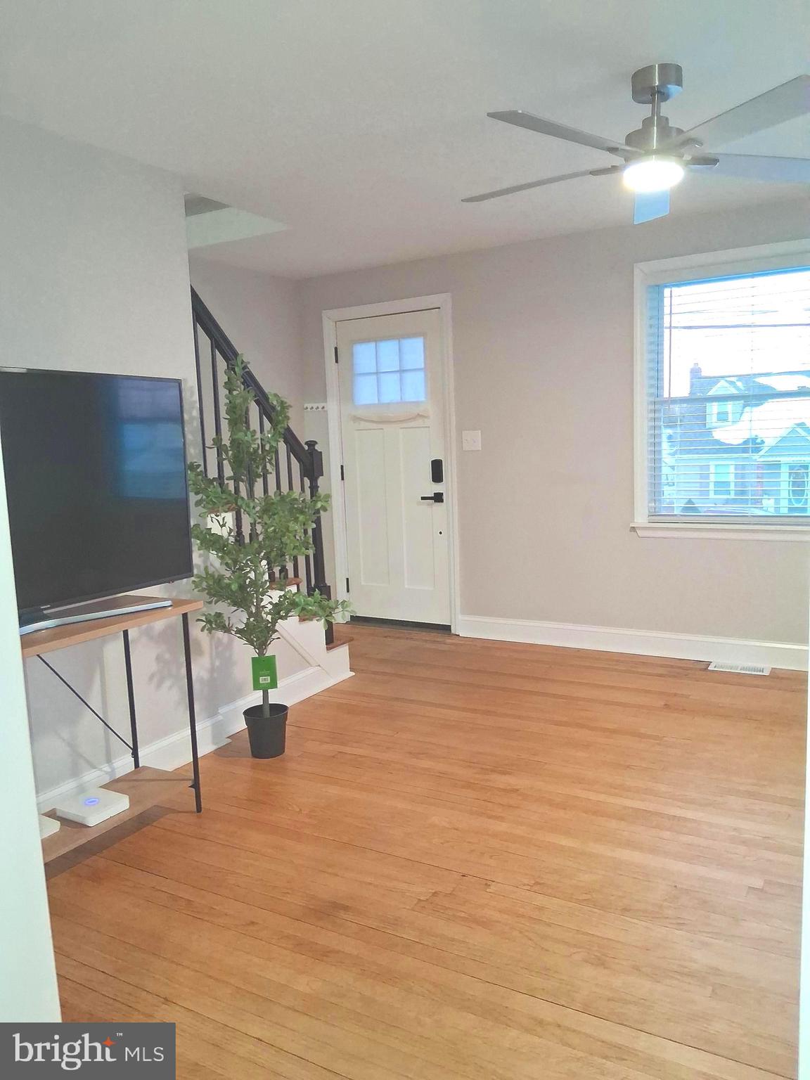 1225 Landover Road Rosedale, MD 21237 - Photo 23 of 48 a view of an empty room with wooden floor and a window