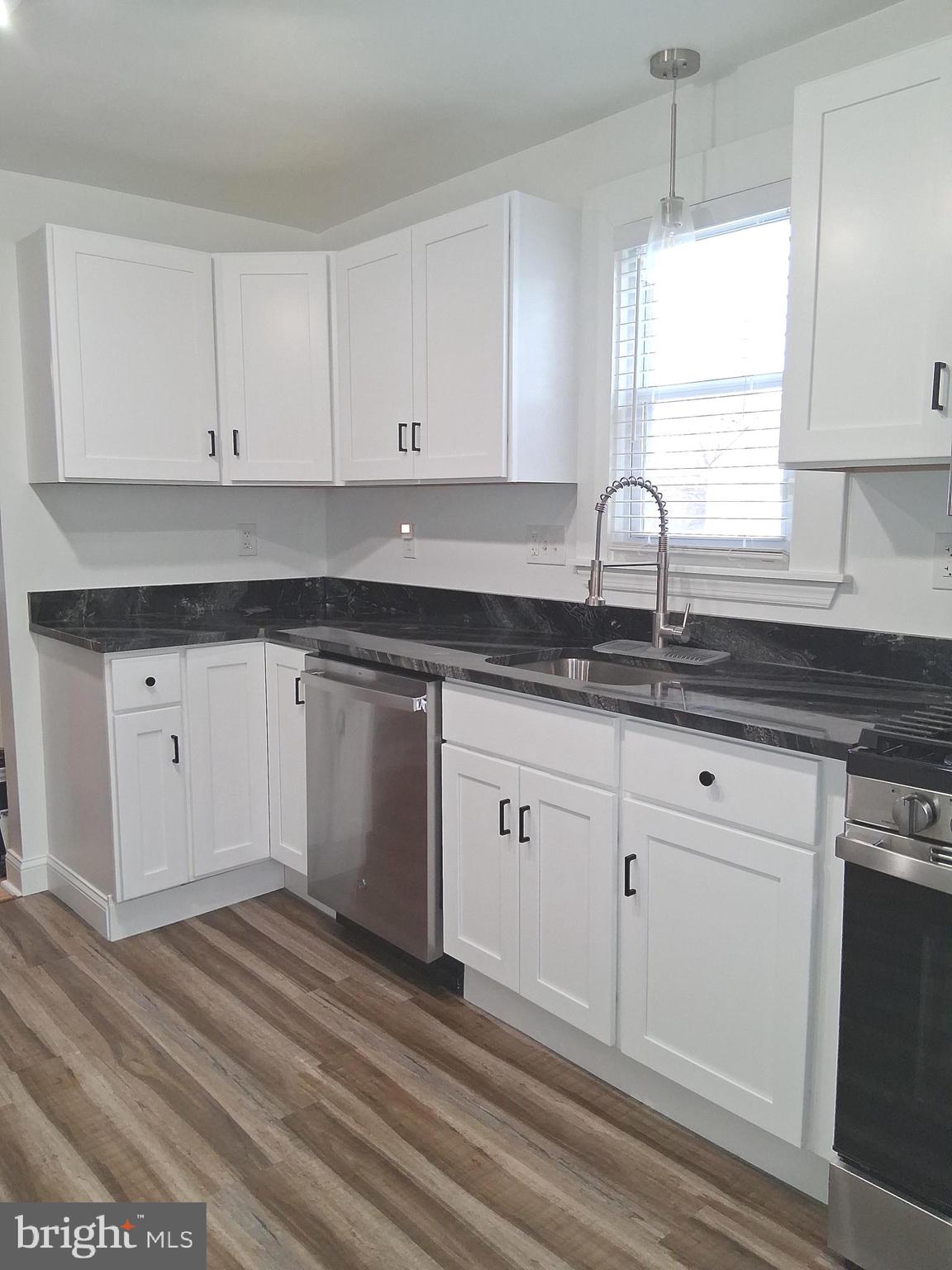 1225 Landover Road Rosedale, MD 21237 - Photo 6 of 48 a kitchen with granite countertop white cabinets white appliances and sink