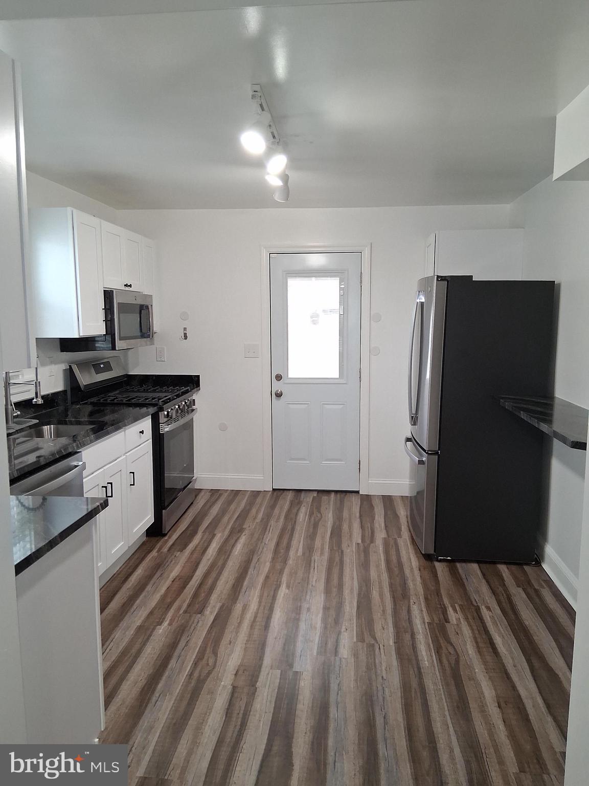 1225 Landover Road Rosedale, MD 21237 - Photo 8 of 48 a kitchen with a refrigerator and a sink